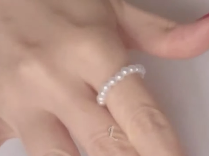 detalle del anillo de perlas en dedo